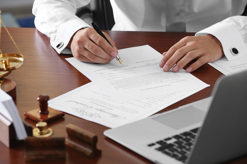 man signing legal will